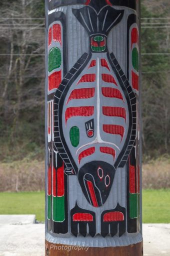 Carving of a halibut on a support pole at a beach shelter, Makah Indian Reservation, Washington