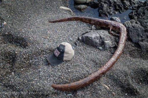 Anchor, or? found on the beach, with a ball cap next to it for size