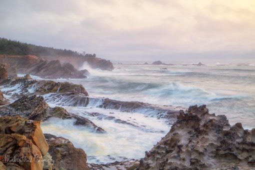 Ocean waves crashing against the sandstone formations at Cape Arago, Oregon