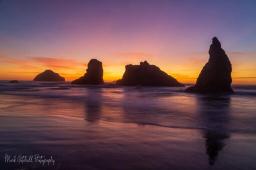 Howling Dog Rock and Face Rock at Bandon Beach after sunset