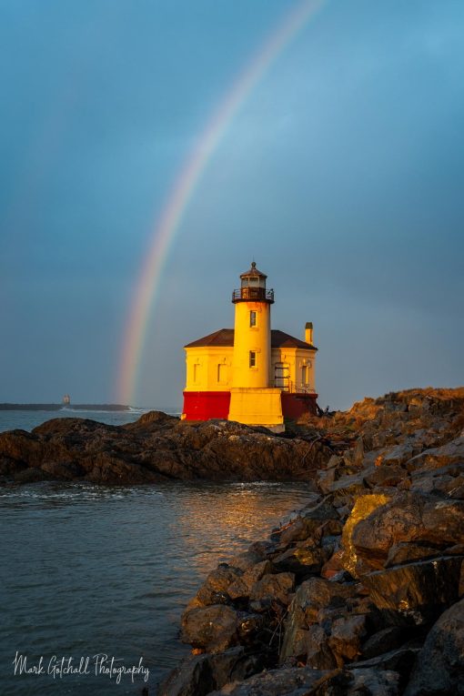 Rainbow over Coquille River Lighthouse, at sunrise, Bandon, Oregon