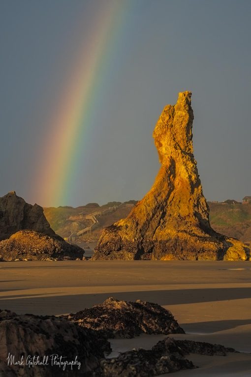 Photo of a rainbow over Howling Dog Rock, Bandon Beach, Oregon