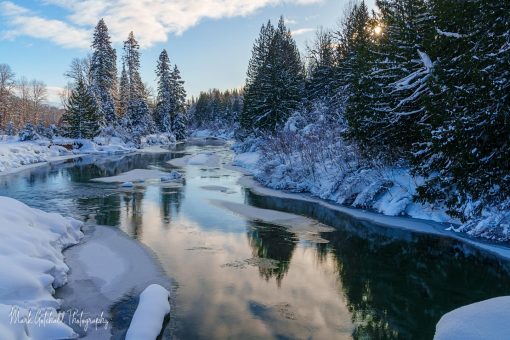 White River Winter Photo of the White River in Winter with snow and blue sky reflected in the river surface.