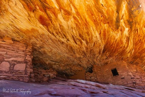 House on Fire, Bears Ears National Monument, Utah Photo of a sandstone cliff above an ancient dwelling that is lit up by the sun reflecting off the rocks