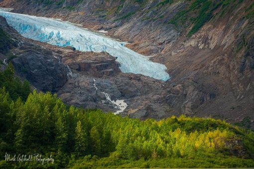 Glacier melting in mountainous landscape, with the start of fall colors