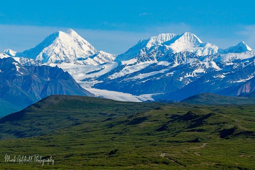 Snowy mountains, in Alaska, under clear blue sky