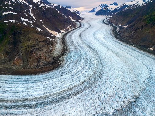 Winding glacier surrounded by mountains