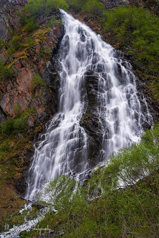 Horsetail Falls Alaska, braided waterfall cascading down a stair step rock face, near Valdez